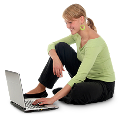 A woman sitting on the ground using a laptop