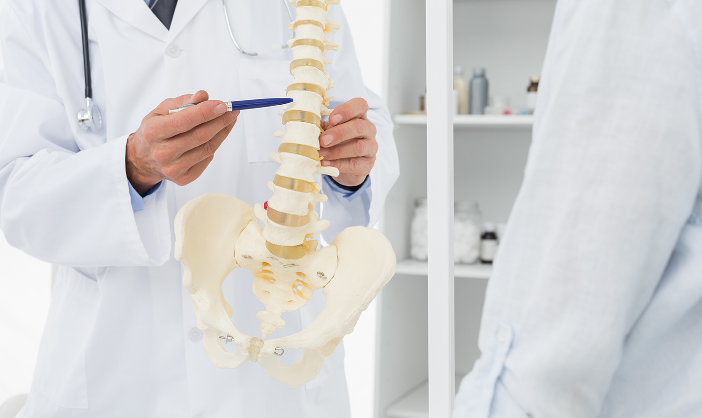 Chiropractor talking to patient about herniated discs